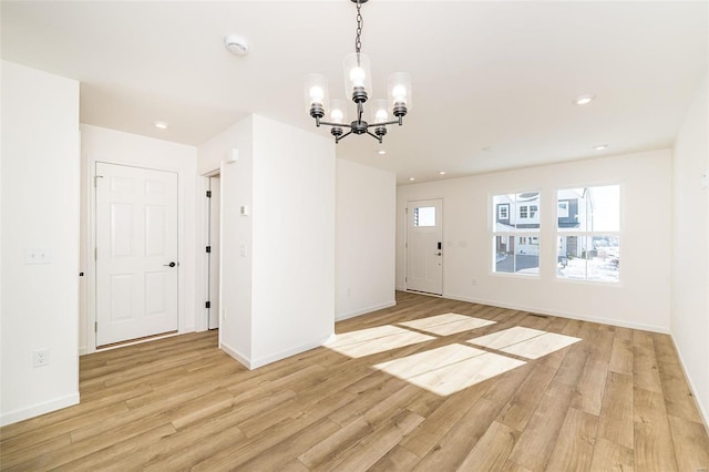 interior space with plenty of natural light, light hardwood / wood-style flooring, and a notable chandelier