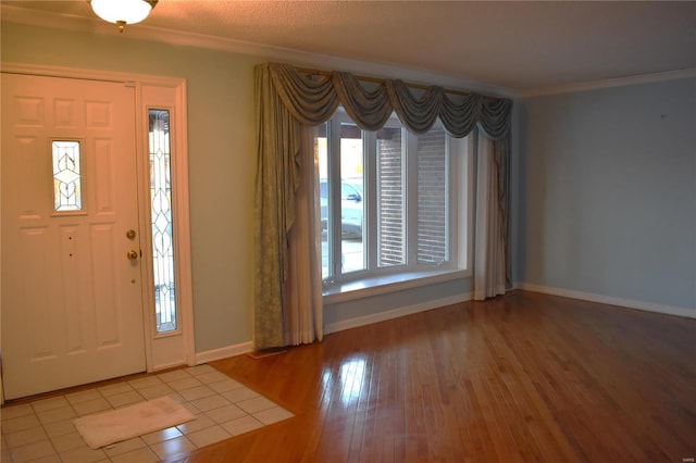 foyer featuring crown molding and hardwood / wood-style flooring