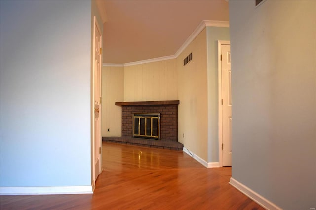 interior space with crown molding, a fireplace, and wood-type flooring