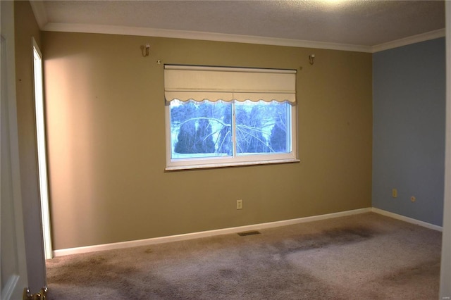 unfurnished room with ornamental molding and carpet