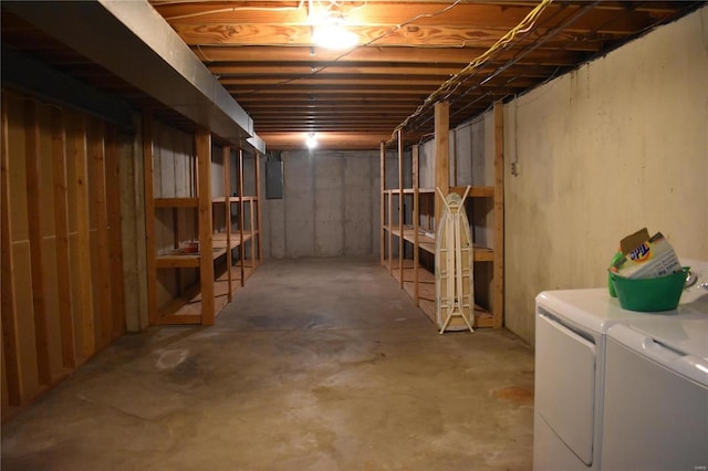 basement featuring electric panel and washing machine and dryer