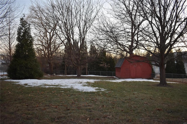 snowy yard with a shed