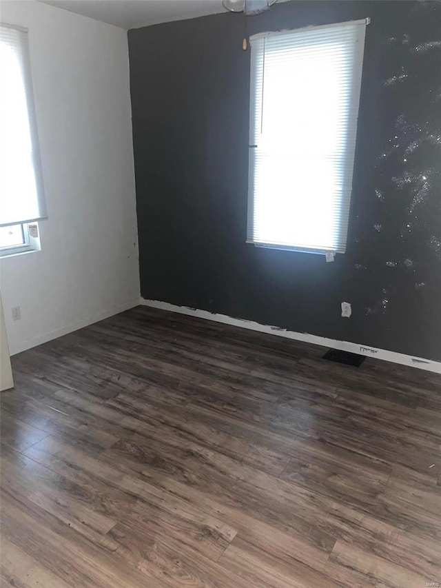 spare room with dark hardwood / wood-style flooring