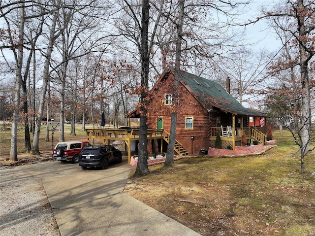 view of front of house with a front yard and a deck