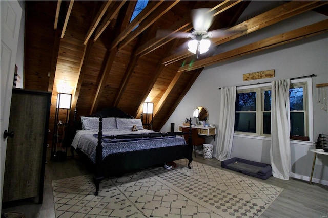 bedroom featuring vaulted ceiling with beams, wooden ceiling, light hardwood / wood-style floors, and ceiling fan