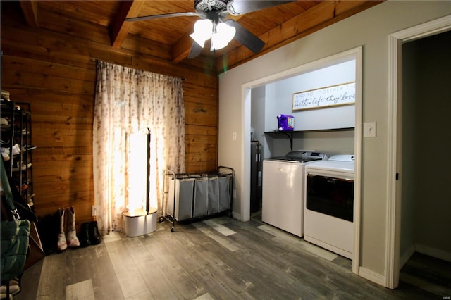 clothes washing area with wood walls, wood ceiling, ceiling fan, washer and clothes dryer, and hardwood / wood-style floors