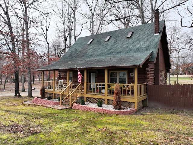 back of house with a porch and a yard