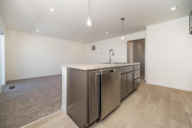 kitchen with decorative light fixtures, sink, stainless steel dishwasher, dark brown cabinetry, and light wood-type flooring