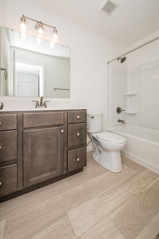 full bathroom with vanity, toilet, shower / bath combination, and hardwood / wood-style floors