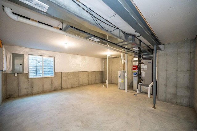 basement featuring water heater, heating unit, and electric panel