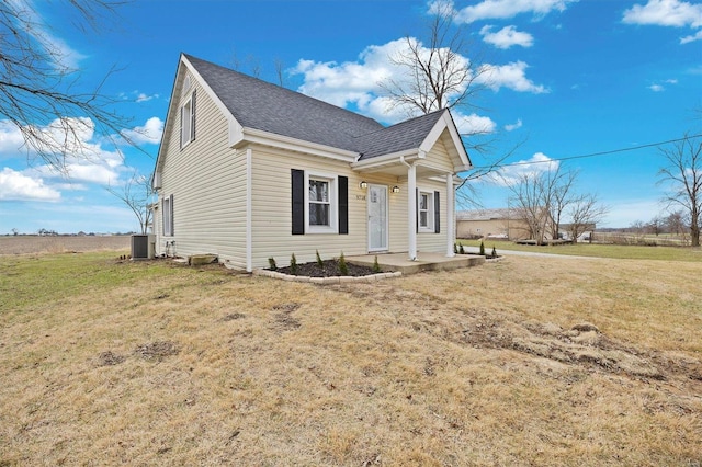 view of front of property with a front lawn and cooling unit