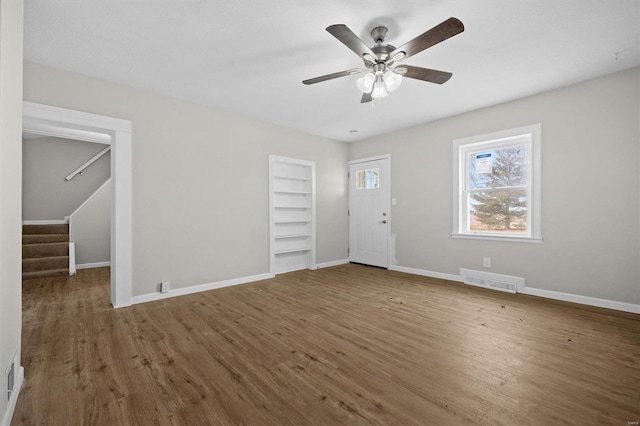 interior space featuring dark hardwood / wood-style flooring and ceiling fan