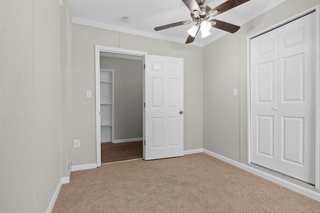 unfurnished bedroom with ceiling fan and light colored carpet