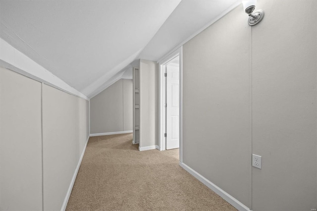 additional living space featuring lofted ceiling and light carpet