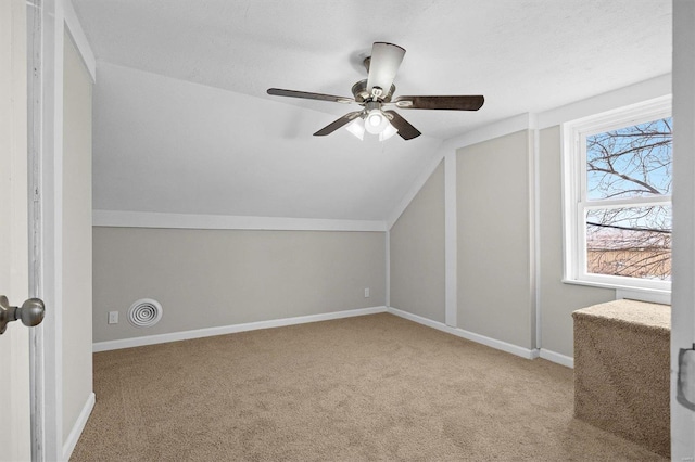 additional living space with light carpet, ceiling fan, and lofted ceiling