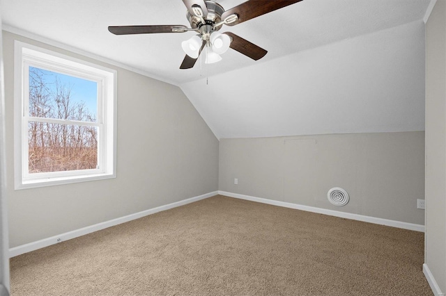 additional living space with carpet flooring, ceiling fan, and lofted ceiling