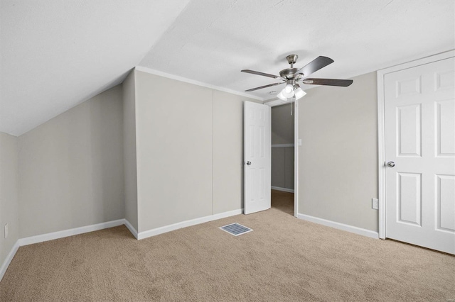 additional living space featuring light colored carpet, ceiling fan, and lofted ceiling