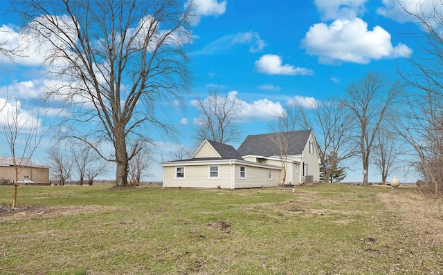 view of side of home with a lawn