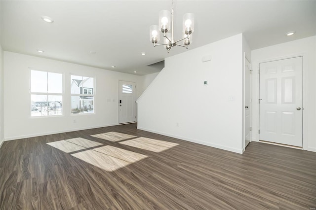 interior space with dark wood-type flooring and a notable chandelier