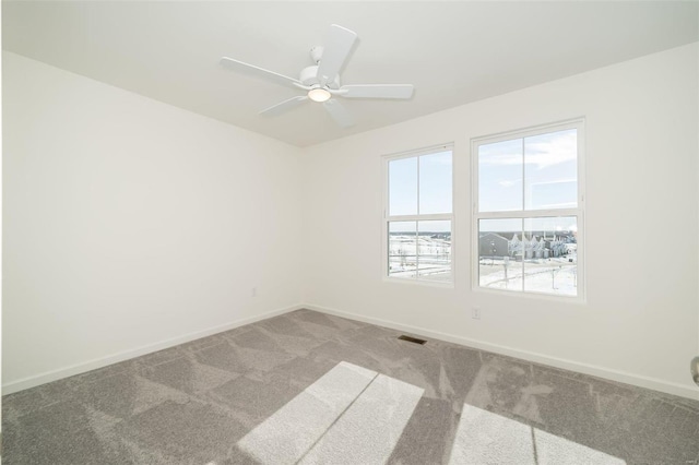 carpeted spare room with ceiling fan