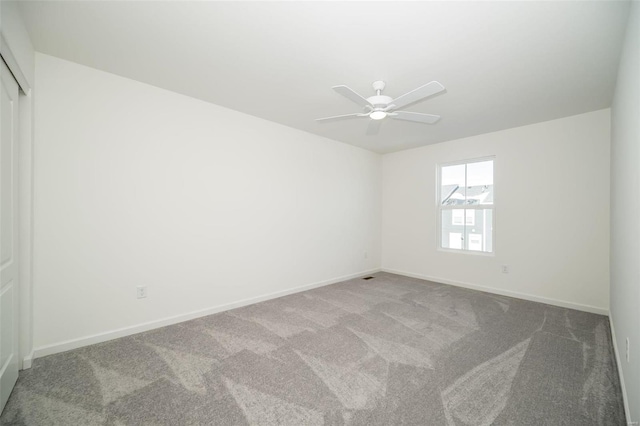 carpeted empty room with ceiling fan