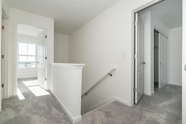 hallway with light colored carpet