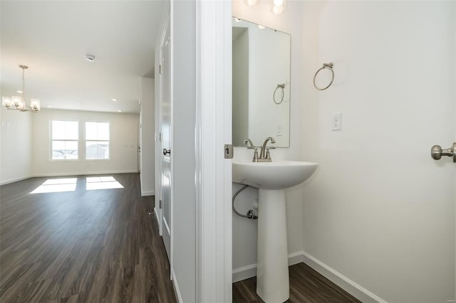 bathroom featuring sink, wood-type flooring, and a chandelier