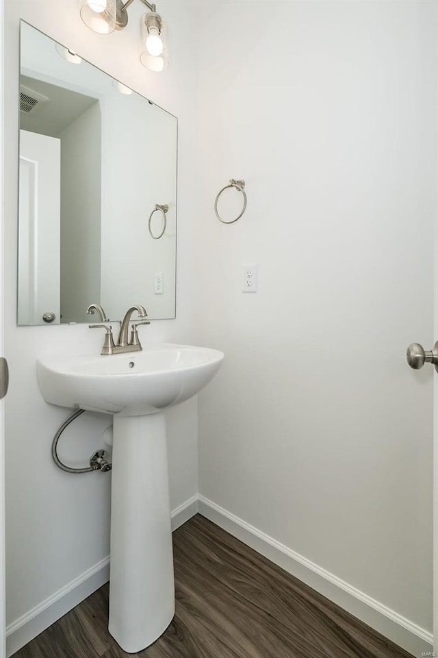 bathroom with hardwood / wood-style flooring and sink