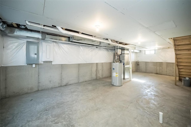 basement featuring electric water heater and electric panel