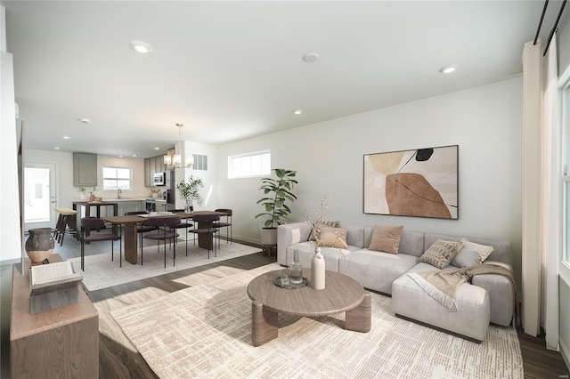 living room featuring wood-type flooring and a chandelier