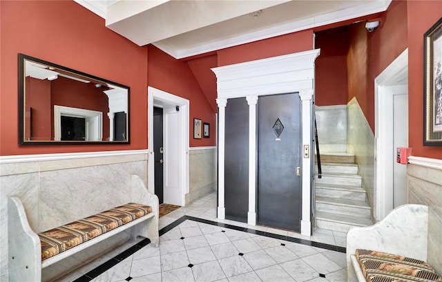 interior space featuring tile patterned flooring and wainscoting