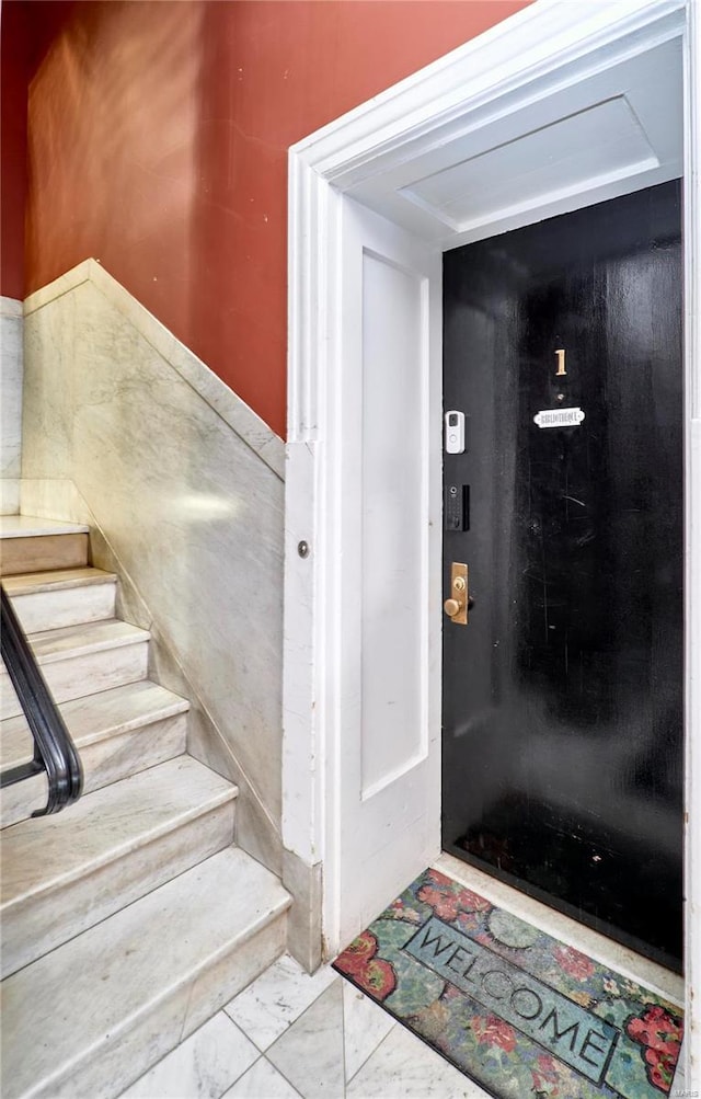 staircase with marble finish floor