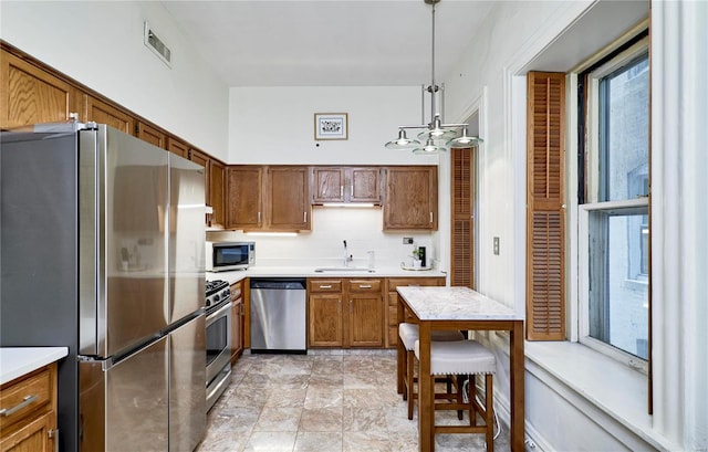 kitchen featuring visible vents, a sink, light countertops, appliances with stainless steel finishes, and backsplash