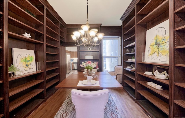 interior space featuring a notable chandelier and wood finished floors