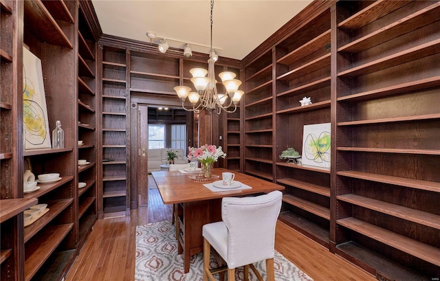 interior space with wood finished floors and a chandelier