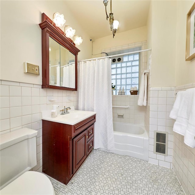 bathroom featuring vanity, visible vents, tile patterned flooring, tile walls, and toilet