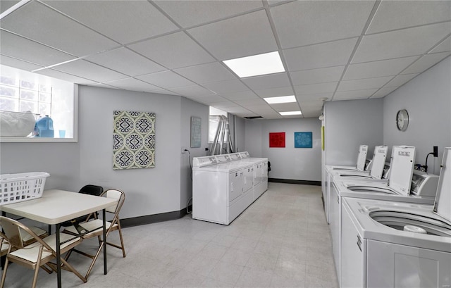 community laundry room featuring independent washer and dryer and baseboards