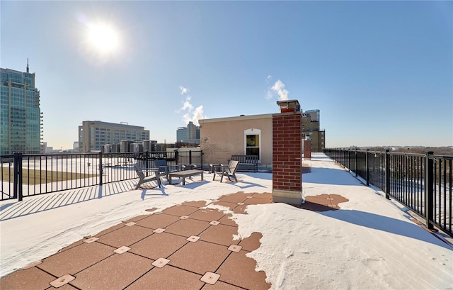 view of patio with a view of city and fence