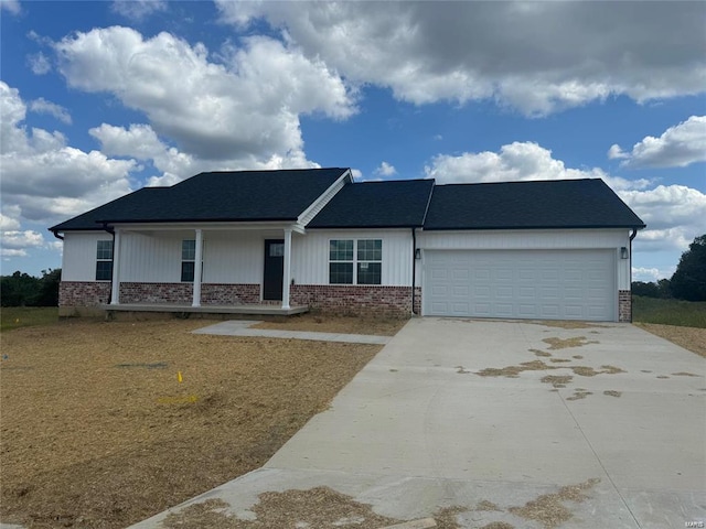 view of front of property with covered porch and a garage