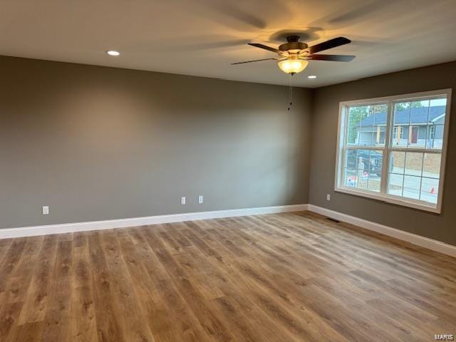 spare room with ceiling fan and hardwood / wood-style flooring