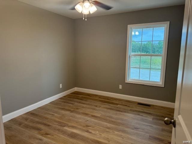 unfurnished room featuring ceiling fan and hardwood / wood-style floors