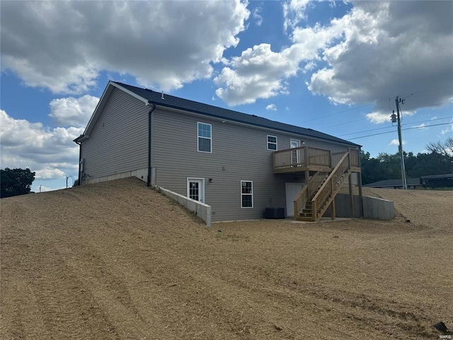 back of property featuring central AC and a wooden deck