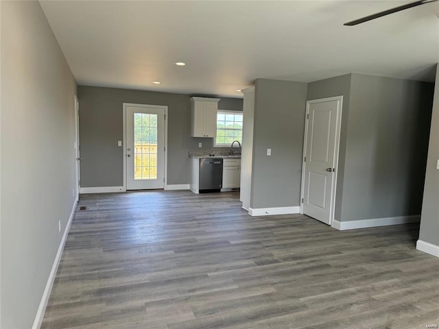 unfurnished living room with ceiling fan and light wood-type flooring