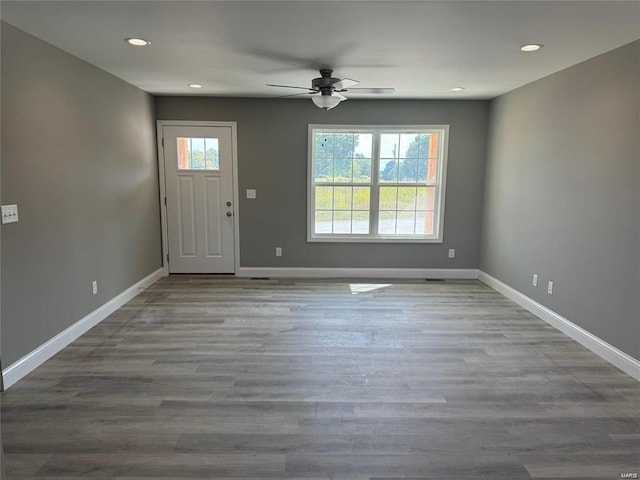 foyer entrance featuring ceiling fan, light hardwood / wood-style floors, and a wealth of natural light