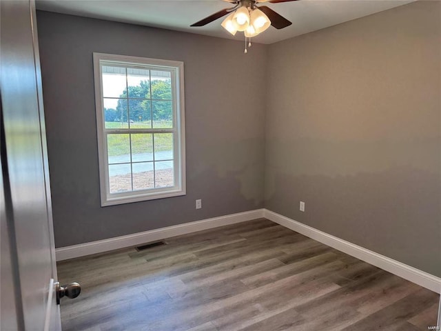 empty room featuring ceiling fan and hardwood / wood-style flooring