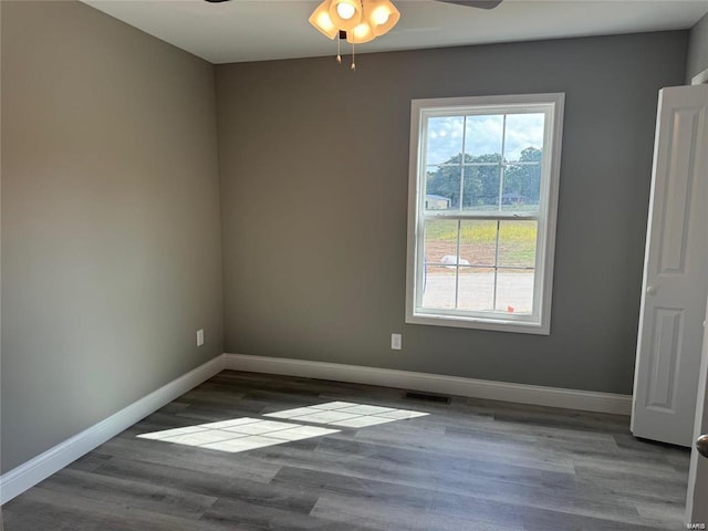 unfurnished room featuring ceiling fan and dark hardwood / wood-style floors