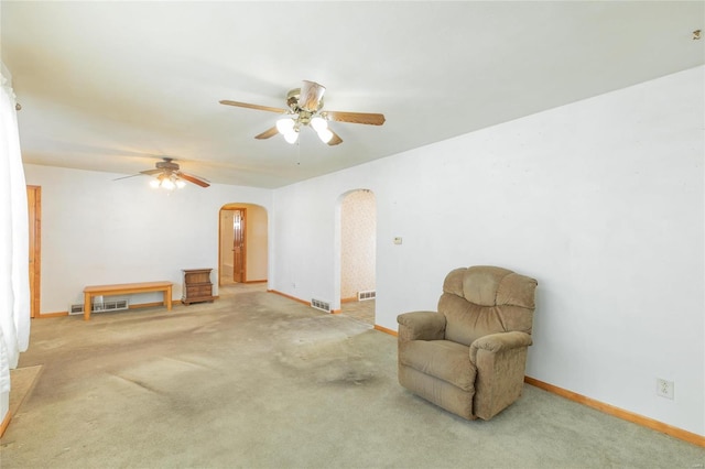 living area featuring ceiling fan and carpet floors