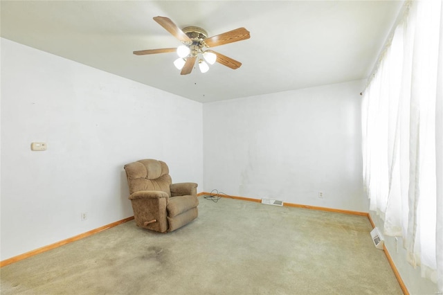 sitting room featuring ceiling fan and carpet floors