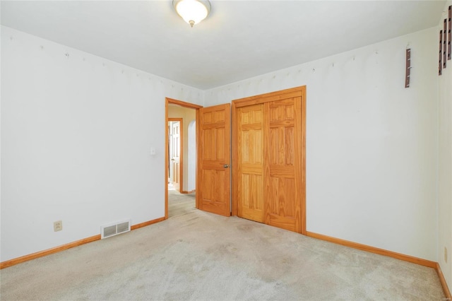 unfurnished bedroom featuring light colored carpet