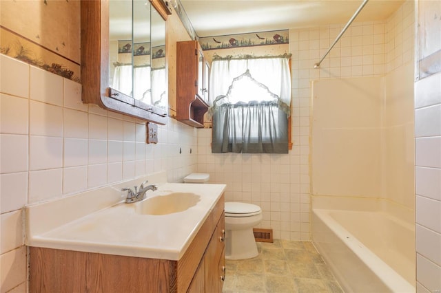 full bathroom featuring vanity, toilet, tile walls, and bathtub / shower combination